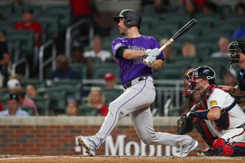 Sep 3, 2024; Atlanta, Georgia, USA; Colorado Rockies catcher Jacob Stallings (25) hits a single against the Atlanta Braves in the seventh inning at Truist Park. Mandatory Credit: Brett Davis-Imagn Images 