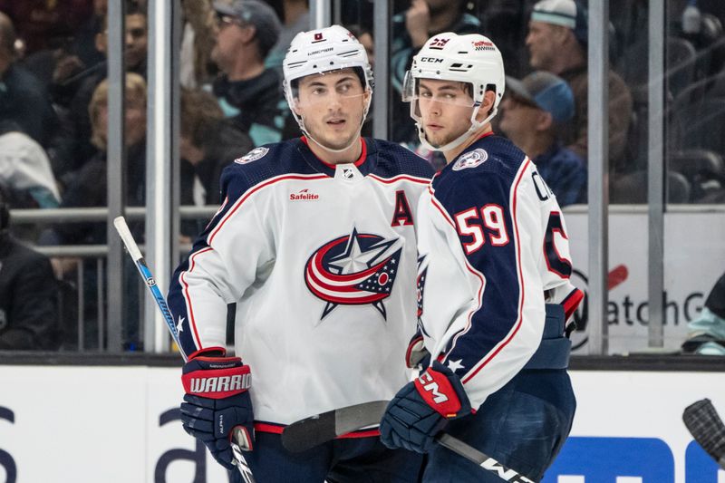 Jan 28, 2024; Seattle, Washington, USA; Columbus Blue Jackets defenseman Zach Werenski (8) and forward Yegor Chinakhov (59) celebrate a goald during the third period Kraken at Climate Pledge Arena. Mandatory Credit: Stephen Brashear-USA TODAY Sports