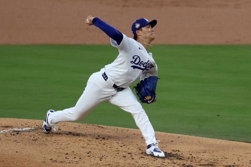 Oct 26, 2024; Los Angeles, California, USA; Los Angeles Dodgers pitcher Yoshinobu Yamamoto (18) throws a pitchl against the New York Yankees in the first inning for game two of the 2024 MLB World Series at Dodger Stadium. Mandatory Credit: Kiyoshi Mio-Imagn Images