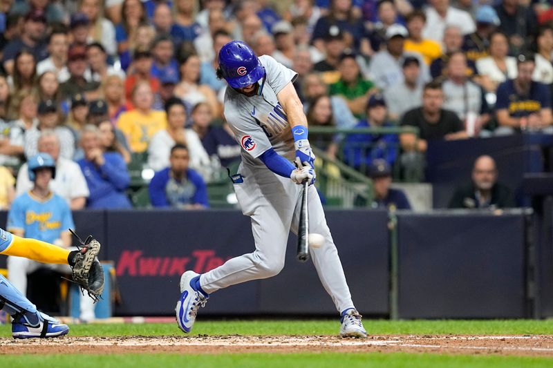 Jun 28, 2024; Milwaukee, Wisconsin, USA;  Chicago Cubs shortstop Dansby Swanson (7) hits an RBI single during the fourth inning against the Milwaukee Brewers at American Family Field. Mandatory Credit: Jeff Hanisch-USA TODAY Sports