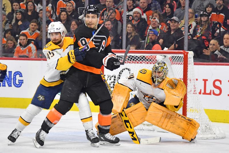 Dec 21, 2023; Philadelphia, Pennsylvania, USA; Philadelphia Flyers right wing Garnet Hathaway (19) and Nashville Predators defenseman Alexandre Carrier (45) battle for the puck in front of goaltender Juuse Saros (74) during the second period at Wells Fargo Center. Mandatory Credit: Eric Hartline-USA TODAY Sports