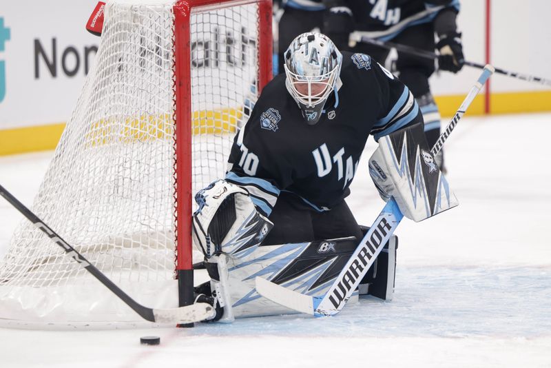 Oct 28, 2024; Salt Lake City, Utah, USA; Utah Hockey Club goaltender Karel Vejmelka (70) defends the goal during warmups before the game against the San Jose Sharks at Delta Center. Mandatory Credit: Chris Nicoll-Imagn Images