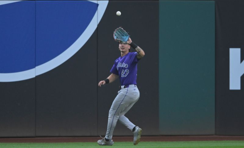 Jul 29, 2025; Cleveland, Ohio, USA; Colorado Rockies left fielder Jordan Beck (27) makes a catch in the first inning against the Cleveland Guardians at Progressive Field. Mandatory Credit: David Richard-Imagn Images