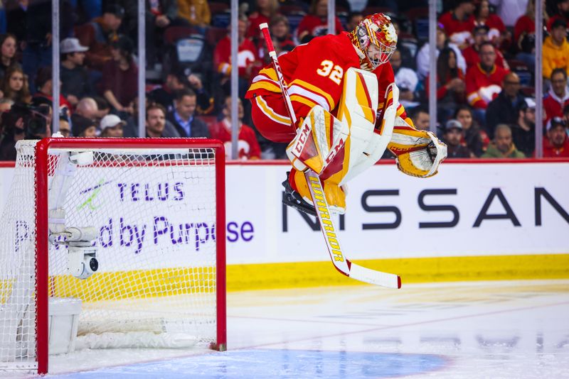 Apr 12, 2023; Calgary, Alberta, CAN; Calgary Flames goaltender Dustin Wolf (32) warms up prior to the start of the game against the San Jose Sharks at Scotiabank Saddledome. Mandatory Credit: Sergei Belski-USA TODAY Sports