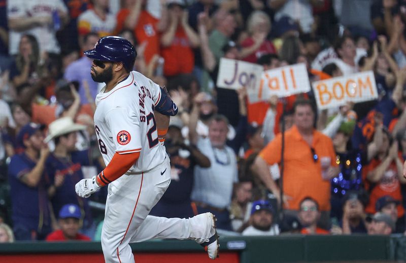 May 21, 2024; Houston, Texas, USA; Fans hold signs as Houston Astros first baseman Jon Singleton (28) rounds the bases after hitting a home run during the sixth inning against the Los Angeles Angels at Minute Maid Park. Mandatory Credit: Troy Taormina-USA TODAY Sports