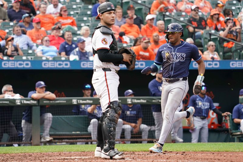 Sep 25, 2025; Baltimore, Maryland, USA; Tampa Bay Rays second baseman Richie Palacios (1) scores during the sixth inning in front of Baltimore Orioles catcher Alex Jackson (70) at Oriole Park at Camden Yards. Mandatory Credit: Mitch Stringer-Imagn Images