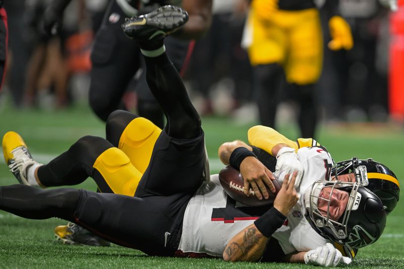 Pittsburgh Steelers linebacker T.J. Watt tackles Atlanta Falcons quarterback Taylor Heinicke during the first half of a preseason NFL football game Thursday, Aug. 24, 2023, in Atlanta. (AP Photo/Hakim Wright)