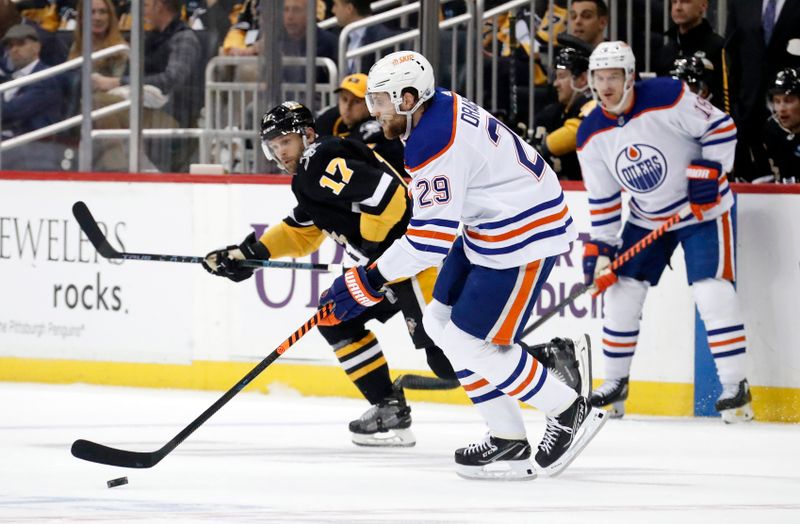 Feb 23, 2023; Pittsburgh, Pennsylvania, USA; Edmonton Oilers center Leon Draisaitl (29) skates with the puck against Pittsburgh Penguins right wing Bryan Rust (17) during the first period at PPG Paints Arena. Mandatory Credit: Charles LeClaire-USA TODAY Sports