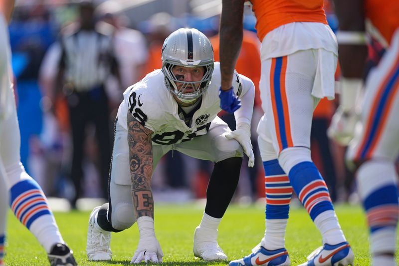 Las Vegas Raiders defensive end Maxx Crosby waits on the snap during the first half of an NFL football game against the Denver Broncos, Sunday, Oct. 6, 2024, in Denver. (AP Photo/David Zalubowski)