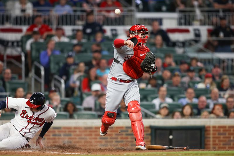 Apr 11, 2023; Atlanta, Georgia, USA; Cincinnati Reds catcher Curt Casali (12) throws a runner out at first against the Atlanta Braves in the seventh inning at Truist Park. Mandatory Credit: Brett Davis-USA TODAY Sports