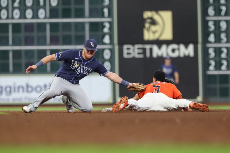 May 30, 2025; Houston, Texas, USA; Houston Astros shortstop Jeremy Pena (3) is safe with a stolen base as Tampa Bay Rays second baseman Curtis Mead (25) attempts to apply a tag during the eighth inning at Daikin Park. Mandatory Credit: Troy Taormina-Imagn Images