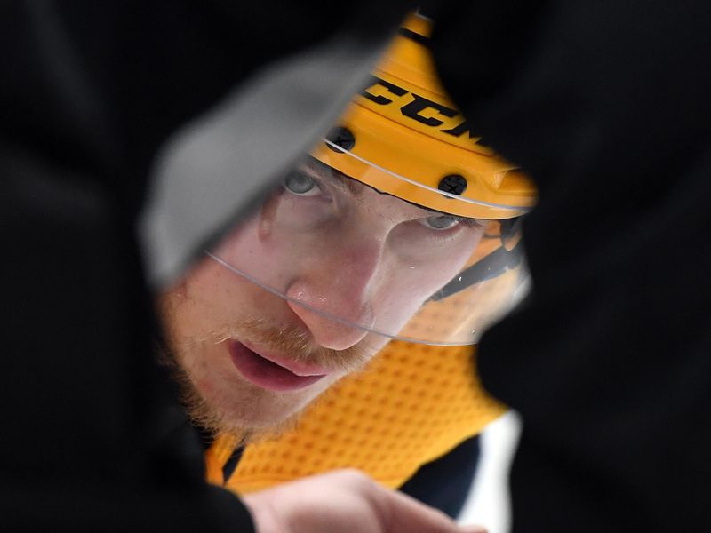 Apr 4, 2023; Nashville, Tennessee, USA; Nashville Predators center Philip Tomasino (26) waits for a linesman to drop the puck on a face off during the third period against the Vegas Golden Knights at Bridgestone Arena. Mandatory Credit: Christopher Hanewinckel-USA TODAY Sports