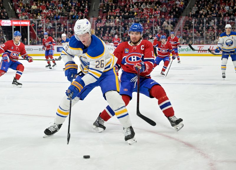 Mar 3, 2025; Montreal, Quebec, CAN; Buffalo Sabres defenseman Rasmus Dahlin (26) plays the puck and Montreal Canadiens forward Nick Suzuki (14) forechecks during the second period at the Bell Centre. Mandatory Credit: Eric Bolte-Imagn Images