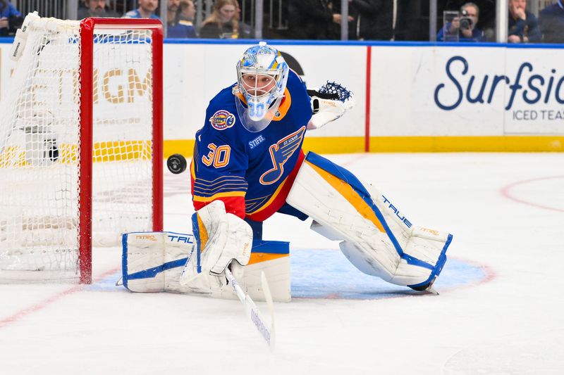Mar 10, 2026; St. Louis, Missouri, USA; St. Louis Blues goaltender Joel Hofer (30) deflects the puck during the third period against the New York Islanders at Enterprise Center. Mandatory Credit: Jeff Curry-Imagn Images