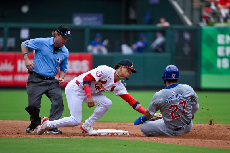 Jul 14, 2024; St. Louis, Missouri, USA;  St. Louis Cardinals shortstop Masyn Winn (0) tags out Chicago Cubs right fielder Seiya Suzuki (27) during the fourth inning at Busch Stadium. Mandatory Credit: Jeff Curry-USA TODAY Sports