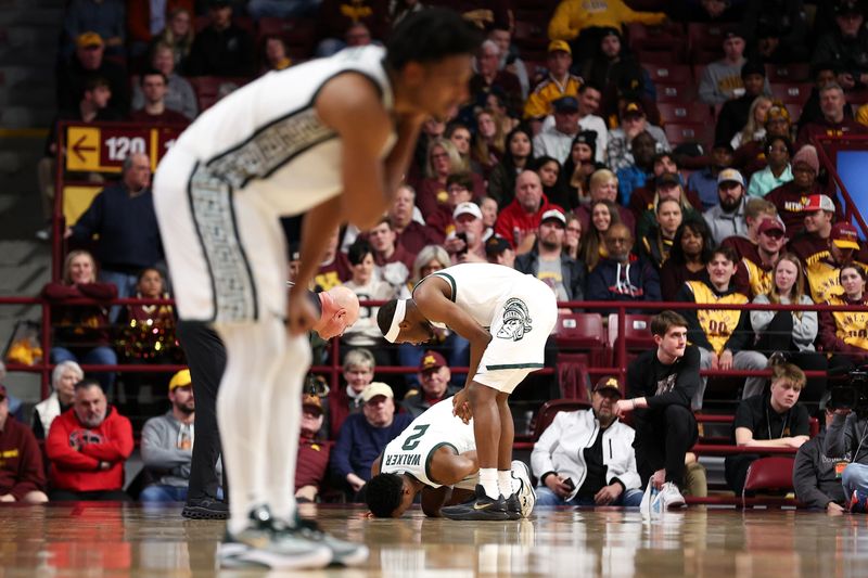 Feb 6, 2024; Minneapolis, Minnesota, USA; Michigan State Spartans guard Tyson Walker (2) lies on the court after an injury during the second half against the Minnesota Golden Gophers at Williams Arena. Mandatory Credit: Matt Krohn-USA TODAY Sports