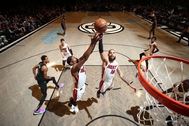 BROOKLYN, NY - JANUARY 15: Caleb Martin #16 of the Miami Heat grabs a rebound during the game against the Brooklyn Nets on January 15, 2024 at Barclays Center in Brooklyn, New York. NOTE TO USER: User expressly acknowledges and agrees that, by downloading and or using this Photograph, user is consenting to the terms and conditions of the Getty Images License Agreement. Mandatory Copyright Notice: Copyright 2024 NBAE (Photo by Nathaniel S. Butler/NBAE via Getty Images)