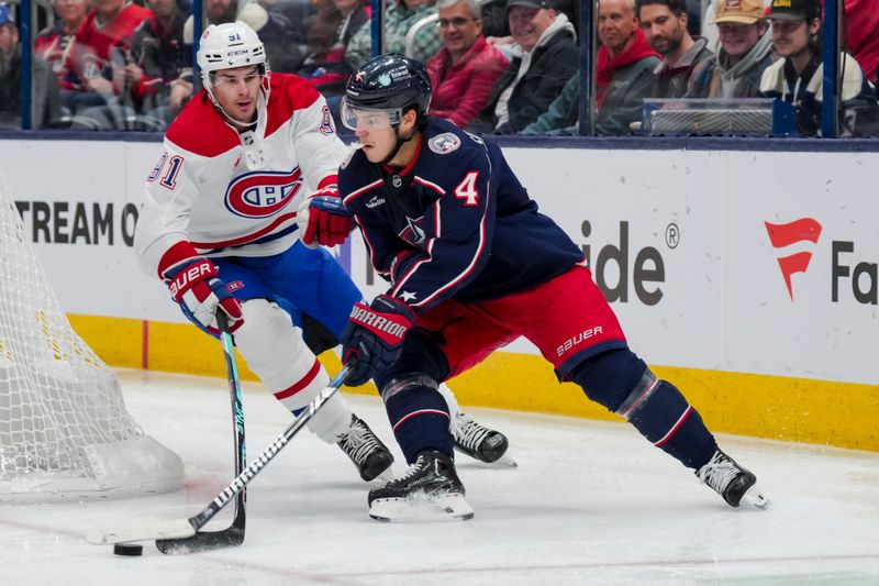 Nov 29, 2023; Columbus, Ohio, USA;  Columbus Blue Jackets center Cole Sillinger (4) skates with the puck against Montreal Canadiens center Sean Monahan (91) in the second period at Nationwide Arena. Mandatory Credit: Aaron Doster-USA TODAY Sports