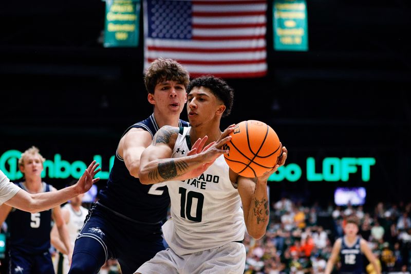 Mar 1, 2025; Fort Collins, Colorado, USA; Colorado State Rams guard Nique Clifford (10) grabs a rebound against Utah State Aggies forward Tucker Anderson (2) in the second half at Moby Arena. Mandatory Credit: Isaiah J. Downing-Imagn Images