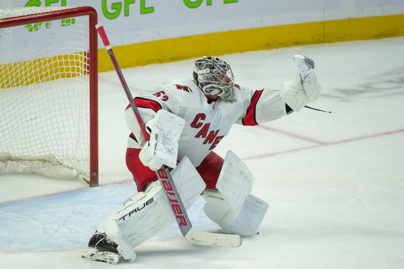 Dec 12, 2023; Ottawa, Ontario, CAN; Carolina Hurricanes goalie Pyotrt Kochetkov (52) makes a save in the third period against the Ottawa Senators at the Canadian Tire Centre. Mandatory Credit: Marc DesRosiers-USA TODAY Sports.