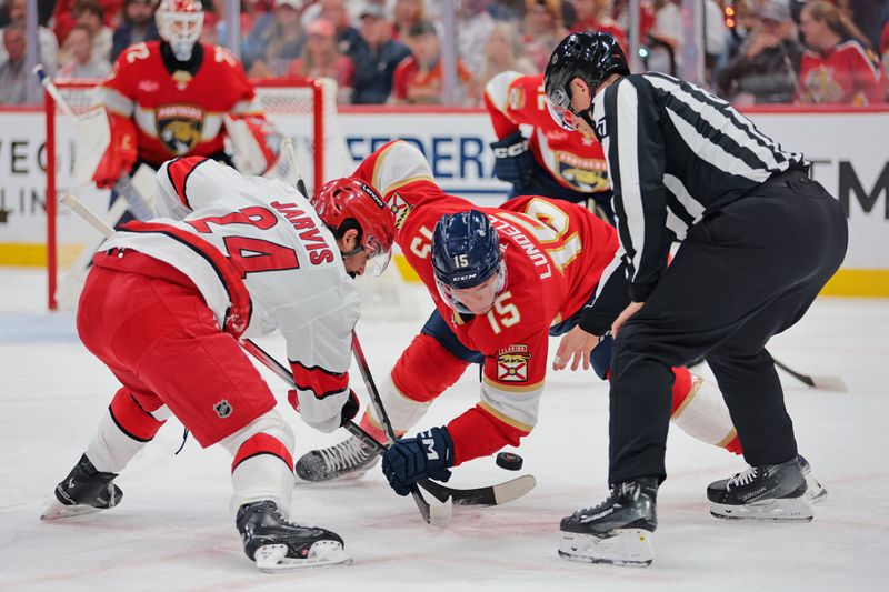 May 26, 2025; Sunrise, Florida, USA; Carolina Hurricanes center Seth Jarvis (24) and Florida Panthers center Anton Lundell (15) face-off during the first period in game four of the Eastern Conference Final of the 2025 Stanley Cup Playoffs at Amerant Bank Arena. Mandatory Credit: Sam Navarro-Imagn Images
