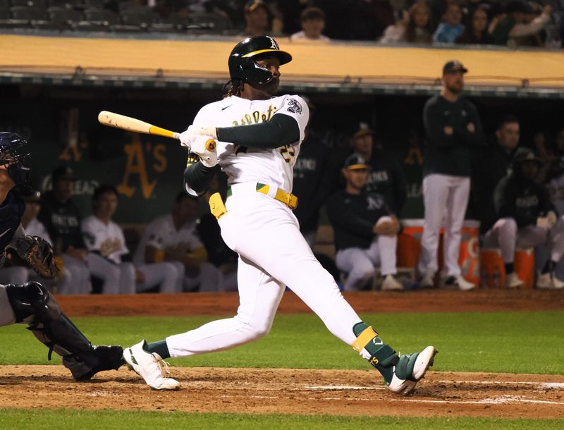 Sep 22, 2023; Oakland, California, USA; Oakland Athletics center fielder Lawrence Butler (22) hits a single against the Detroit Tigers during the sixth inning at Oakland-Alameda County Coliseum. Mandatory Credit: Kelley L Cox-USA TODAY Sports