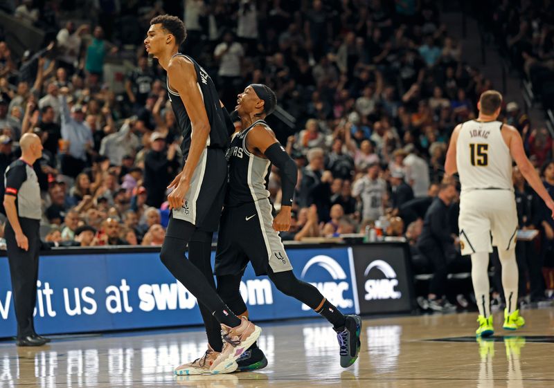 SAN ANTONIO, TX - APRIL 12: Victor Wembanyama #1 of the San Antonio Spurs celebrates with Devonte Graham #4 of the San Antonio Spurs after scoring a three against the Denver Nuggetsin the second half at Frost Bank Center on April 12, 2024 in San Antonio, Texas. NOTE TO USER: User expressly acknowledges and agrees that, by downloading and or using this photograph, User is consenting to terms and conditions of the Getty Images License Agreement. (Photo by Ronald Cortes/Getty Images)