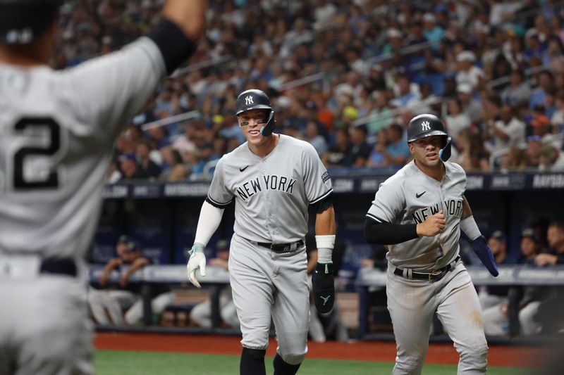 Aug 25, 2023; St. Petersburg, Florida, USA; New York Yankees right fielder Aaron Judge (99) and second baseman Gleyber Torres (25) score runs during the seventh inning against the Tampa Bay Rays at Tropicana Field. Mandatory Credit: Kim Klement Neitzel-USA TODAY Sports