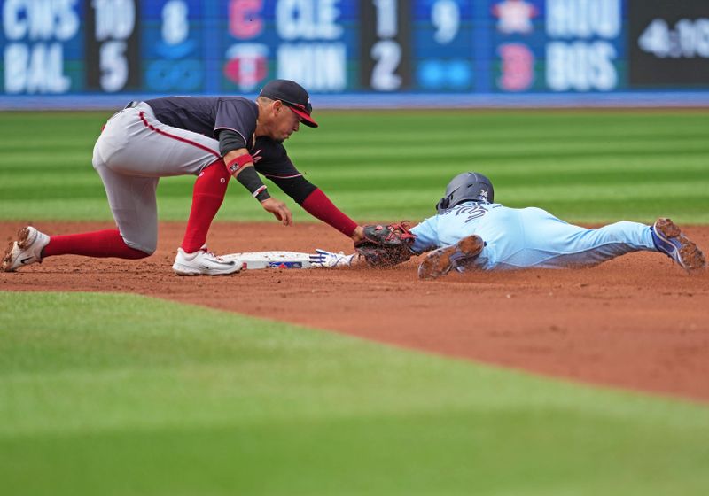 Aug 30, 2023; Toronto, Ontario, CAN; Toronto Blue Jays second baseman Davis Schneider (36) is tagged out at second base by Washington Nationals second baseman Ildemaro Vargas (14) during the third inning at Rogers Centre. Mandatory Credit: Nick Turchiaro-USA TODAY Sports