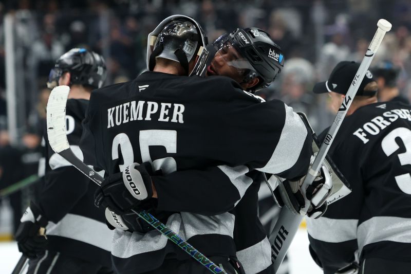 Jan 3, 2026; Los Angeles, California, USA;  Los Angeles Kings goaltender Darcy Kuemper (35) celebrates with right wing Quinton Byfield (right) after defeating the Minnesota Wild 5-4 at Crypto.com Arena. Mandatory Credit: Kiyoshi Mio-Imagn Images