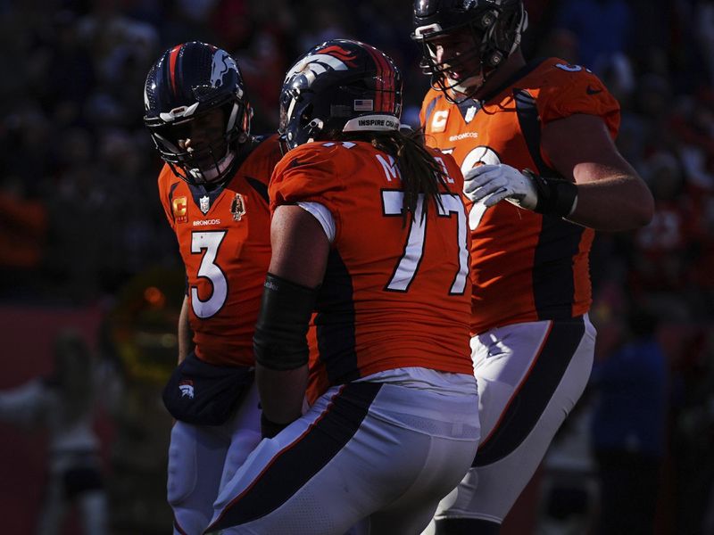 Denver Broncos quarterback Russell Wilson (3) scores a touchdown against the Cleveland Browns of an NFL football game Sunday November 26, 2023, in Denver. (AP Photo/Bart Young)