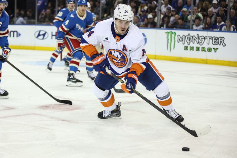 Nov 8, 2025; New York, New York, USA;  New York Islanders center Bo Horvat (14) controls the puck in the second period against the New York Rangers at Madison Square Garden. Mandatory Credit: Wendell Cruz-Imagn Images