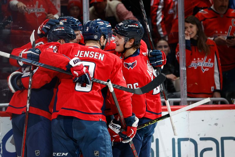 Feb 11, 2024; Washington, District of Columbia, USA; Washington Capitals right wing Nic Dowd (26) celebrates with teammates after scoring a goal against the Vancouver Canucks in the first period at Capital One Arena. Mandatory Credit: Geoff Burke-USA TODAY Sports