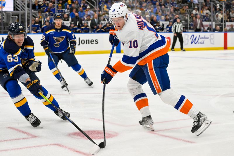 Oct 17, 2024; St. Louis, Missouri, USA;  New York Islanders right wing Simon Holmstrom (10) shoots as St. Louis Blues left wing Jake Neighbours (63) defends during the first period at Enterprise Center. Mandatory Credit: Jeff Curry-Imagn Images