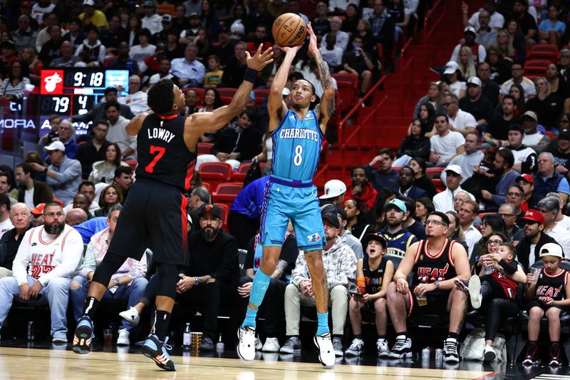 MIAMI, FLORIDA - JANUARY 14: Nick Smith Jr. #8 of the Charlotte Hornets shoots the ball against Kyle Lowry #7 of the Miami Heat during the fourth quarter at Kaseya Center on January 14, 2024 in Miami, Florida. NOTE TO USER: User expressly acknowledges and agrees that, by downloading and or using this photograph, User is consenting to the terms and conditions of the Getty Images License Agreement.  (Photo by Megan Briggs/Getty Images)