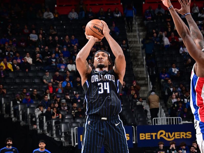 DETROIT, MI - JANUARY 1: Wendell Carter Jr. #34 of the Orlando Magic shoots a three point basket during the game against the Detroit Pistons on January 1, 2025 at Little Caesars Arena in Detroit, Michigan. NOTE TO USER: User expressly acknowledges and agrees that, by downloading and/or using this photograph, User is consenting to the terms and conditions of the Getty Images License Agreement. Mandatory Copyright Notice: Copyright 2025 NBAE (Photo by Chris Schwegler/NBAE via Getty Images)