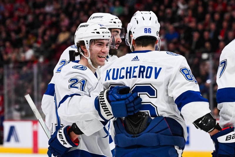 Apr 4, 2024; Montreal, Quebec, CAN; Tampa Bay Lightning right wing Nikita Kucherov (86) celebrates his goal against the Montreal Canadiens with center Brayden Point (21) during the second period at Bell Centre. Mandatory Credit: David Kirouac-USA TODAY Sports