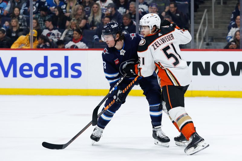 Mar 15, 2024; Winnipeg, Manitoba, CAN; Winnipeg Jets forward Tyler T0ffoli (73) jostles for position with Anaheim Ducks defenseman Olen Zellweger (51) during the second period at Canada Life Centre. Mandatory Credit: Terrence Lee-USA TODAY Sports