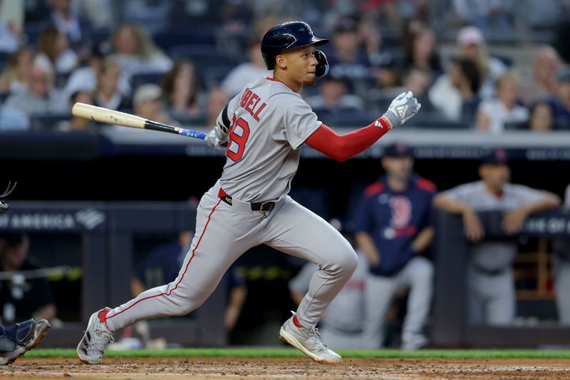 Jun 7, 2025; Bronx, New York, USA; Boston Red Sox second baseman Kristian Campbell (28) follows through on an RBI single against the New York Yankees during the third inning at Yankee Stadium. Mandatory Credit: Brad Penner-Imagn Images