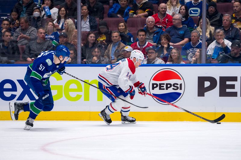 Mar 21, 2024; Vancouver, British Columbia, CAN; Montreal Canadiens forward Nick Suzuki (14) drives past Vancouver Canucks defenseman Tyler Myers (57) in the second period at Rogers Arena. Mandatory Credit: Bob Frid-USA TODAY Sports