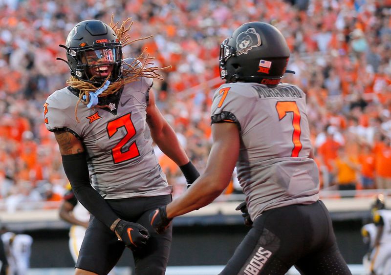 Sep 17, 2022; Stillwater, Oklahoma, USA; Oklahoma State Cowboys cornerback Korie Black (2) celebrates with cornerback Jabbar Muhammad (7) after scoring a touchdown on a blocked field goal against the Arkansas-Pine Bluff Golden Lions at Boone Pickens Stadium. Mandatory Credit: Sarah Phipps-USA TODAY Sports

