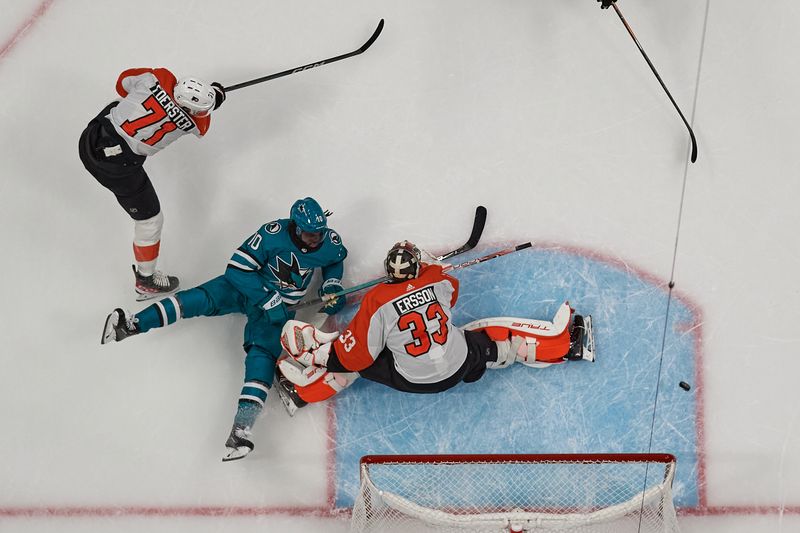 Nov 7, 2023; San Jose, California, USA; San Jose Sharks left wing Anthony Duclair (10) shoots the puck against Philadelphia Flyers goaltender Samuel Ersson (33) and right wing Tyson Foerster (71) during the first period at SAP Center at San Jose. Mandatory Credit: Robert Edwards-USA TODAY Sports