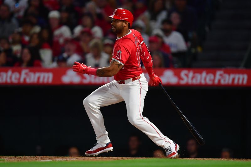 Apr 27, 2024; Anaheim, California, USA; Los Angeles Angels designated hitter Aaron Hicks (12) hits an RBI single against the Minnesota Twins during the third inning at Angel Stadium. Mandatory Credit: Gary A. Vasquez-USA TODAY Sports