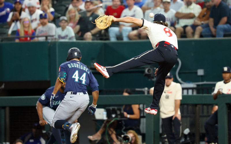 Jun 27, 2025; Arlington, Texas, USA;  Texas Rangers first baseman Josh Smith (8) cannot catch a throw as Seattle Mariners center fielder Julio Rodriguez (44) is safe at first base during the first inning at Globe Life Field. Mandatory Credit: Kevin Jairaj-Imagn Images