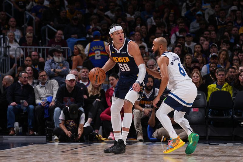 DENVER, CO - APRIL 10: Aaron Gordon #50 of the Denver Nuggets handles the ball against Jordan McLaughlin #6 of the Minnesota Timberwolves during the game on April 10, 2024 at the Ball Arena in Denver, Colorado. NOTE TO USER: User expressly acknowledges and agrees that, by downloading and/or using this Photograph, user is consenting to the terms and conditions of the Getty Images License Agreement. Mandatory Copyright Notice: Copyright 2024 NBAE (Photo by Bart Young/NBAE via Getty Images)