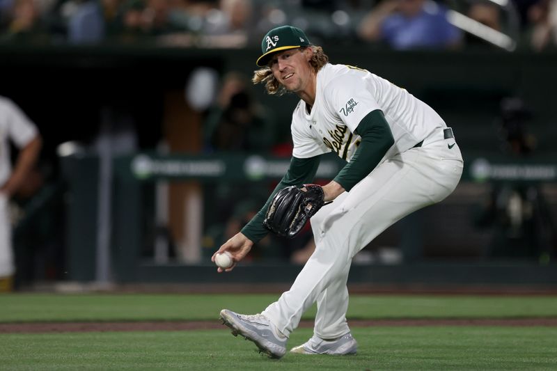 May 24, 2025; West Sacramento, California, USA; Athletics pitcher Tyler Ferguson (44) bare hands a grounder against the Philladelphia Phillies during the eighth inning at Sutter Health Park. Mandatory Credit: Dennis Lee-Imagn Images