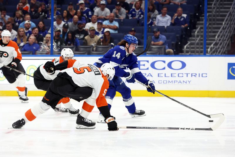 Nov 7, 2024; Tampa, Florida, USA; Tampa Bay Lightning center Conor Geekie (14) passes the puck as Philadelphia Flyers defenseman Egor Zamula (5) defends during the third period at Amalie Arena. Mandatory Credit: Kim Klement Neitzel-Imagn Images