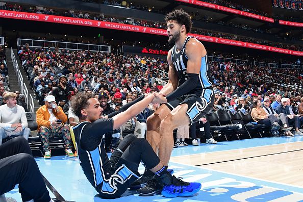 ATLANTA, GA - DECEMBER 23: Seth Lundy #3 of the Atlanta Hawks helps up Trae Young #11 during the game against the Memphis Grizzlies on December 23, 2023 at State Farm Arena in Atlanta, Georgia.  NOTE TO USER: User expressly acknowledges and agrees that, by downloading and/or using this Photograph, user is consenting to the terms and conditions of the Getty Images License Agreement. Mandatory Copyright Notice: Copyright 2023 NBAE (Photo by Scott Cunningham/NBAE via Getty Images)