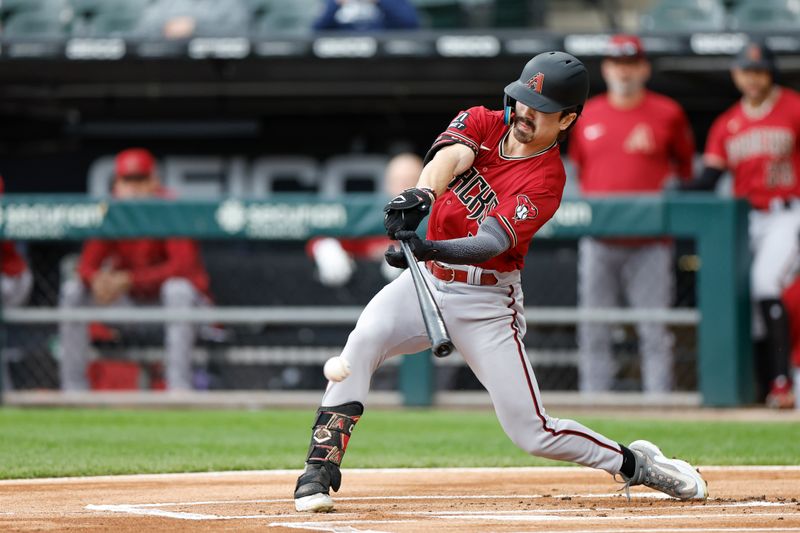 Sep 28, 2023; Chicago, Illinois, USA; Arizona Diamondbacks left fielder Corbin Carroll (7) singles against the Chicago White Sox during the first inning at Guaranteed Rate Field. Mandatory Credit: Kamil Krzaczynski-USA TODAY Sports