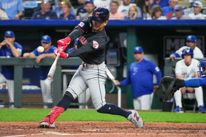 Sep 3, 2024; Kansas City, Missouri, USA; Cleveland Guardians second baseman Andrés Giménez (0) hits a one-run double against the Kansas City Royals in the fifth inning at Kauffman Stadium. Mandatory Credit: Denny Medley-Imagn Images